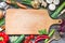 Spice herbs and vegetables food background and empty cutting board