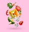 Spice mix for cooking. Set of falling fresh vegetables and herbs on pink background