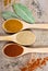 Spice powder on a wooden background. Closeup on paprika, curry and ginger.