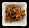 Spice star anise in a ceramic bowl.
