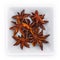 Spice star anise in a white bowl