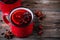 Spiced Pomegranate Apple Cider Mulled Wine Sangria in red mugs on wooden background.