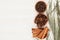 Spices - aniseed, cinnamon, cloves and herbs in wooden bowls on a wood white background.