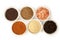 Spices for any dish. an assortment of colorful spices against a white background.