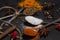 Spices on a black background. Spoons with different spices on a dark surface.