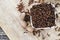 spices of cloves scattered on an old wooden table