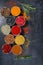 Spices. Colorful spices. Curry, Saffron, turmeric, cinnamon and otheron a dark concrete background. Pepper. Large collection of di