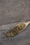 Spices dried coriander seed in spoon wood on old kitchen table.