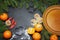 Spices flour orange pine tree branch and empty plate on a black board winter christmas background