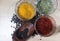 Spices in a glass bowl on a wood background.