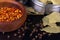 Spices and herbs, bay leaf, black pepper and wooden bowl of chili flakes