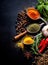 Spices and herbs on wooden table. Spices condiments and herbs on black background.