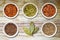 Spices in Pots on Old Wooden Chopping Board