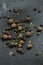 Spices scattered, black pepper. Photo of food on a dark background