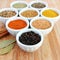 Spices in white bowls â€“ Pepper in the foreground