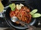 Spicy aceh noodle with vegetable in the black plate