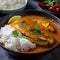 Spicy Bangladeshi Hilsa Curry with Rice and Salad