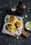 Spicy bean tostadas with corn salsa and avocado and beer