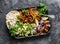 Spicy beef, vegetables, avocado, corn tortillas fajitas on a sheet pan on a dark background, top view. Delicious snack, tapas in