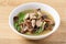 Spicy brown jelly mushroom soup with pork in a bowl