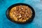Spicy Chana chat masala chotpoti in a black dish isolated on background top view of indian, bangali and pakistani food chat pata