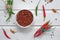 Spicy chili on a light background, flatlay. Used as an ingredient for harissa, ajika, muhammara. East and middle East kitchen