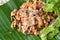 Spicy chop pork salad on banana leaf