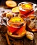 Spicy citrus hot tea with ginger, cloves, cinnamon and orange slices, delicious, warming and healthy in glass cups