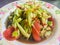 Spicy cucumber salad, Thai street food with tomato and chilli on dish. This spicy Thai cucumber salad has a classic Asian flavor,