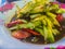 Spicy cucumber salad, Thai street food with tomato and chilli on dish. This spicy Thai cucumber salad has a classic Asian flavor,