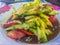 Spicy cucumber salad, Thai street food with tomato and chilli on dish. This spicy Thai cucumber salad has a classic Asian flavor,