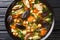 Spicy diet soup with mushrooms, vegetables and chickpeas closeup in a bowl. Horizontal top view