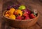 Spicy fruit salad on banana leaf in black dish on Rattan background.