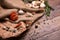 Spicy garlic, a transparent bank of hot red peppers, quail eggs and rosemary on a crumpled paper and wooden background.