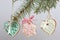 Spicy gingerbread cookie decorated with multi-colored sugar icing. Suspended on a cord. Decorated with spruce branch