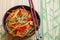 Spicy glass noodles with vegetables - carrots, cucumber, peppers, garlic. Dish Asian and Oriental cuisine