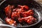 Spicy glazed marinated chicken wings in a dark pan