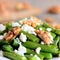 Spicy green beans salad with cottage cheese and walnuts. Summer green beans recipe. Closeup