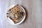 Spicy grilled stingray on a white plate on a wooden patterned table