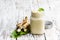 Spicy horseradish sauce in glass jar on wooden table