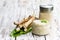 Spicy horseradish sauce in glass jar on wooden table