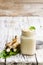 Spicy horseradish sauce in glass jar on wooden table