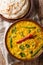Spicy Indian thick soup Dal Tadka is a popular North Indian recipe close up in a bowl. Vertical top view