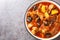 Spicy lamb stew with prunes, tomatoes, potatoes and saffron close-up on a plate on the table. horizontal top view