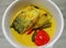 Spicy Malaysian yellow curry with Spanish mackerel and cut tomatoes