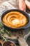 Spicy mashed sweet potato or sweet potato puree with rosemary in a saucepan on a table.  top view from above