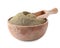 Spicy milled black pepper in wooden bowl with scoop isolated