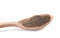 Spicy milled black pepper in wooden spoon isolated