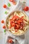 Spicy penne bolognese with herbs and bacon