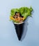 Spicy POKE SALMON wrap topping with salad leaves isolated on sky blue background top view fast food